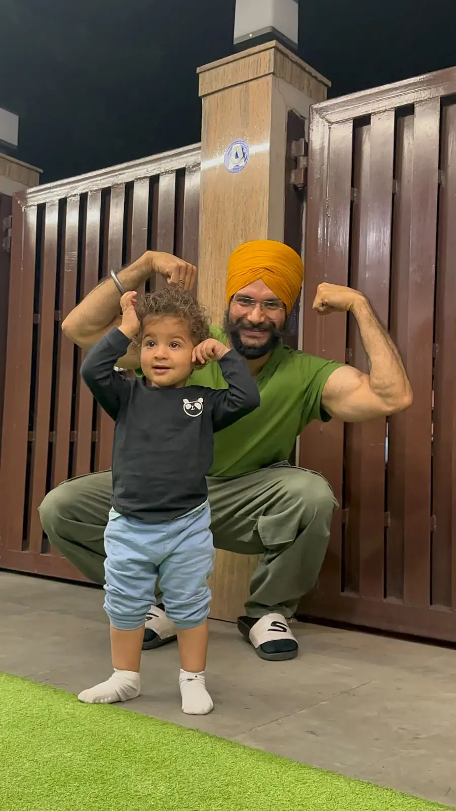 Coach Arsh with his son, both flexing